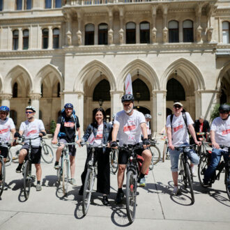 Gruppenfoto von Erich Fenninger, Tanja Wehsely und Radfahrenden vor dem Start